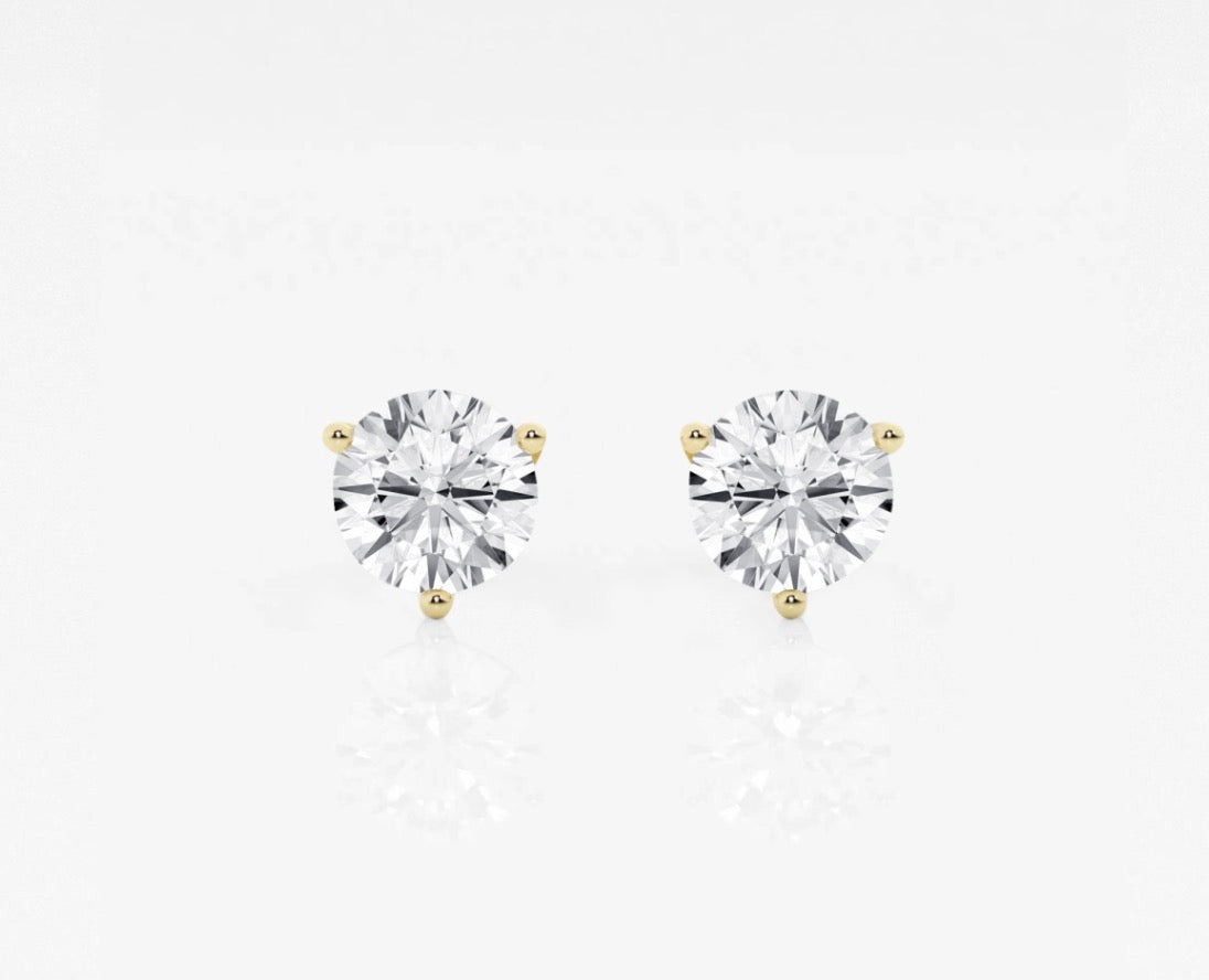 Front view of a pair of lab grown diamond earrings set in yellow gold. 