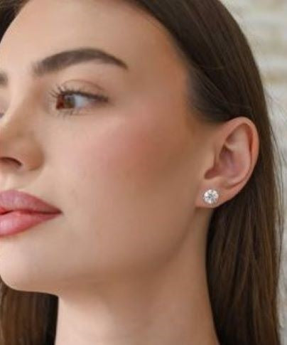 Woman wearing round stud lab grown diamond earring.